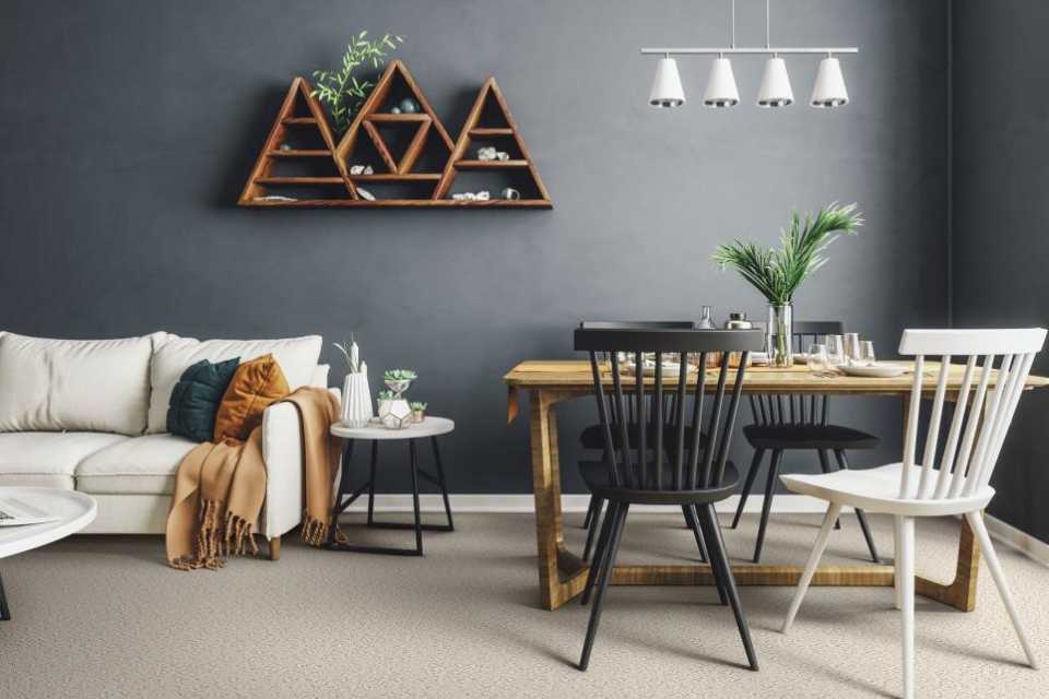 beige floral patterned carpet in open shelving living dining area with grey walls